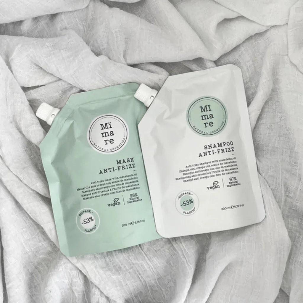 Mimare natural cosmetic anti-frizz shampoo and mask with macadamia oil in eco-friendly packaging on white fabric, vegan hair care